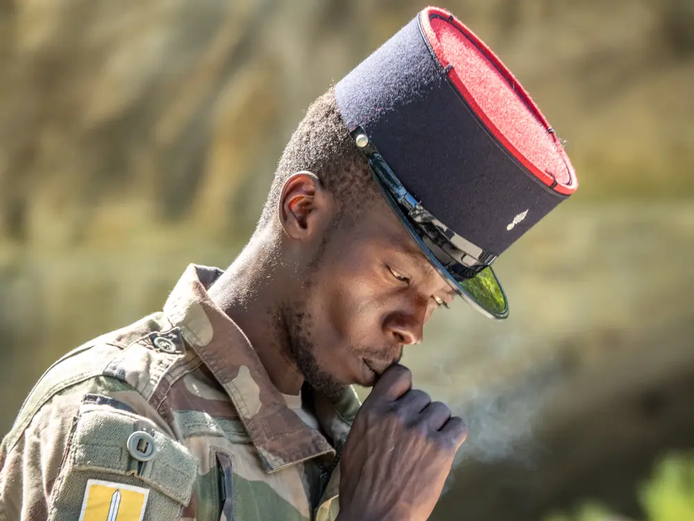 Soldat en treillis portant un képi lors de la cérémonie de remise marquant la fin de la marche du képi blanc.